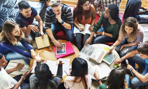 college students sitting in a circle studying and discussing