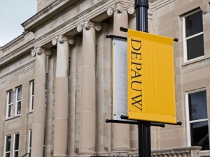 Emison Hall at Depauw University with a university banner hanging from a light post