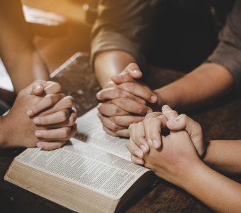 Group of different women praying together