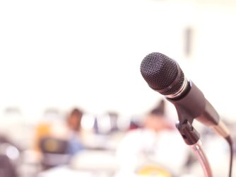 Microphone in conference on seminar room event background