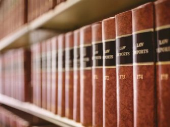 Legal books lined up on a library shelf