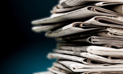 Pile of newspapers on blue background