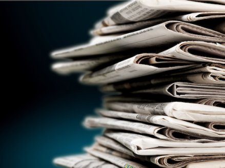 Pile of newspapers on blue background