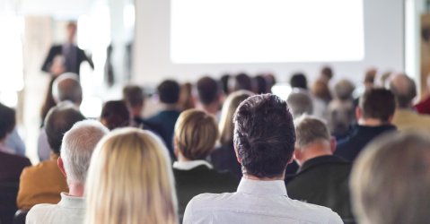 Speaker Giving a Talk at Business Meeting. Audience in the conference hall