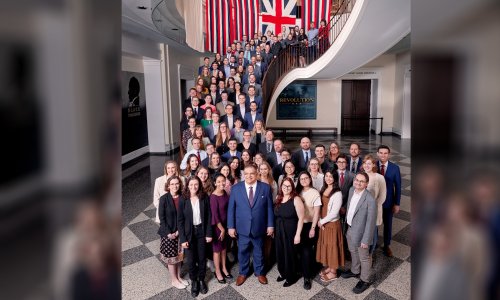 Group photo of FIRE's staff on the grand staircase at the Museum of the American Revolution