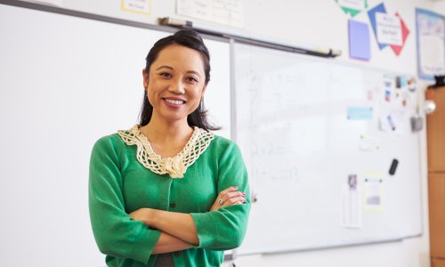 teacher standing in front of white board