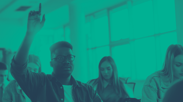 Student raising his hand in a classroom